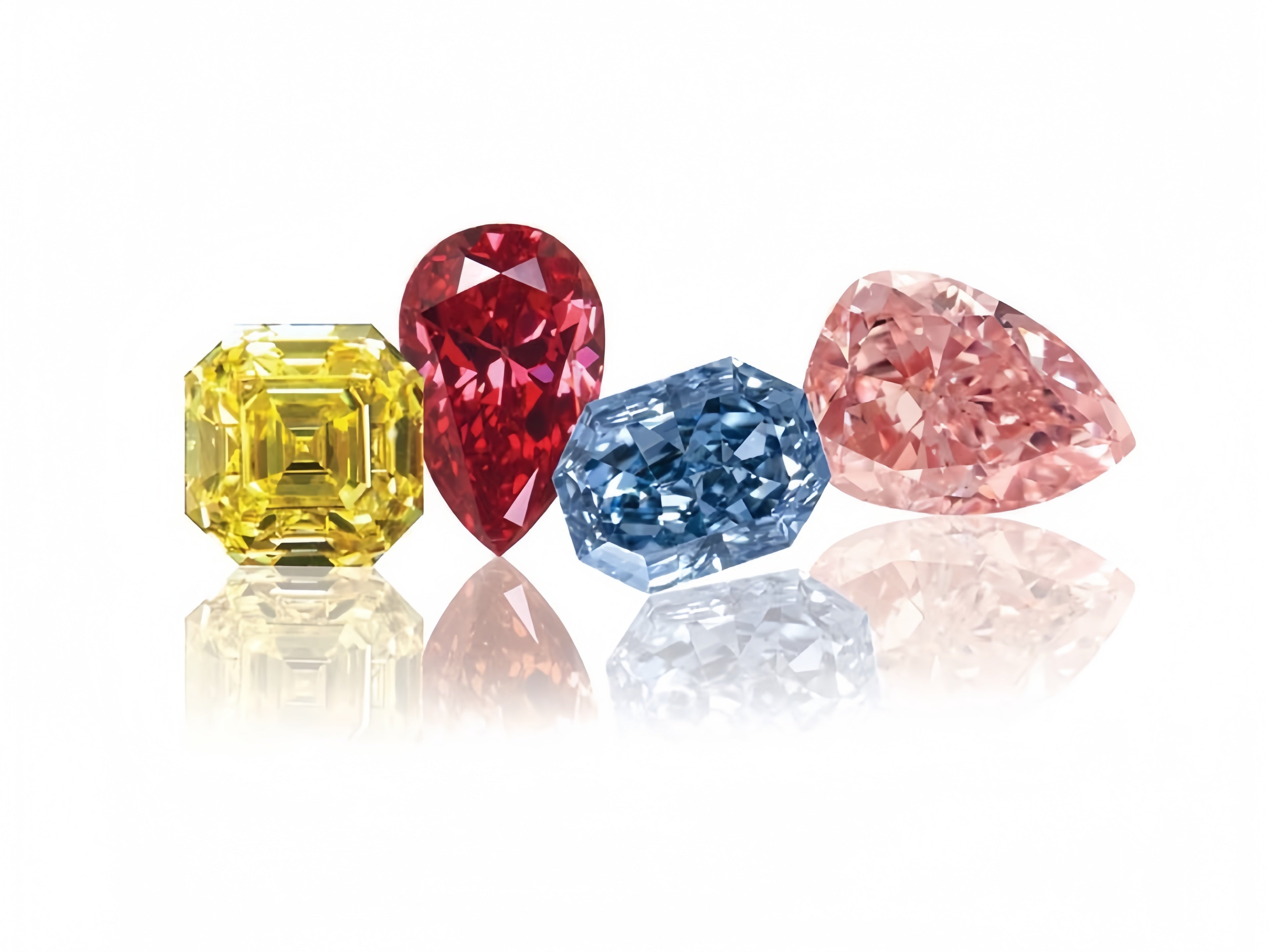 Four loose diamonds of different colors